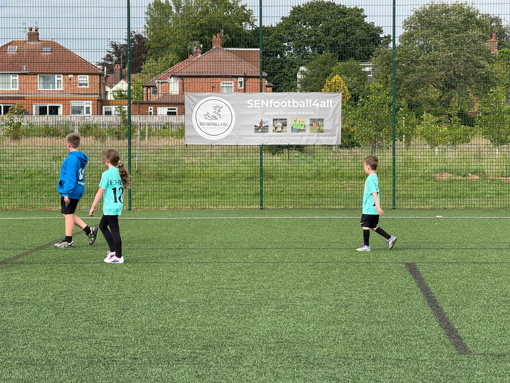 Children playing football and smiling in a safe, supportive environment